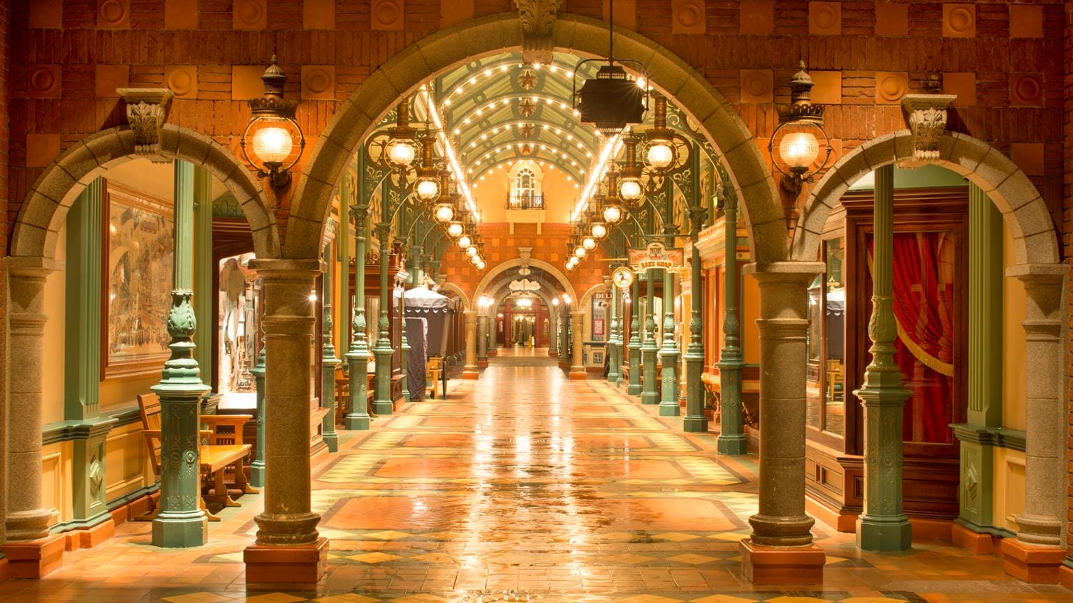 Richly decorated, warmly illuminated interior and curvature with arched stone doors, decorative columns and bright DLP covering lights.