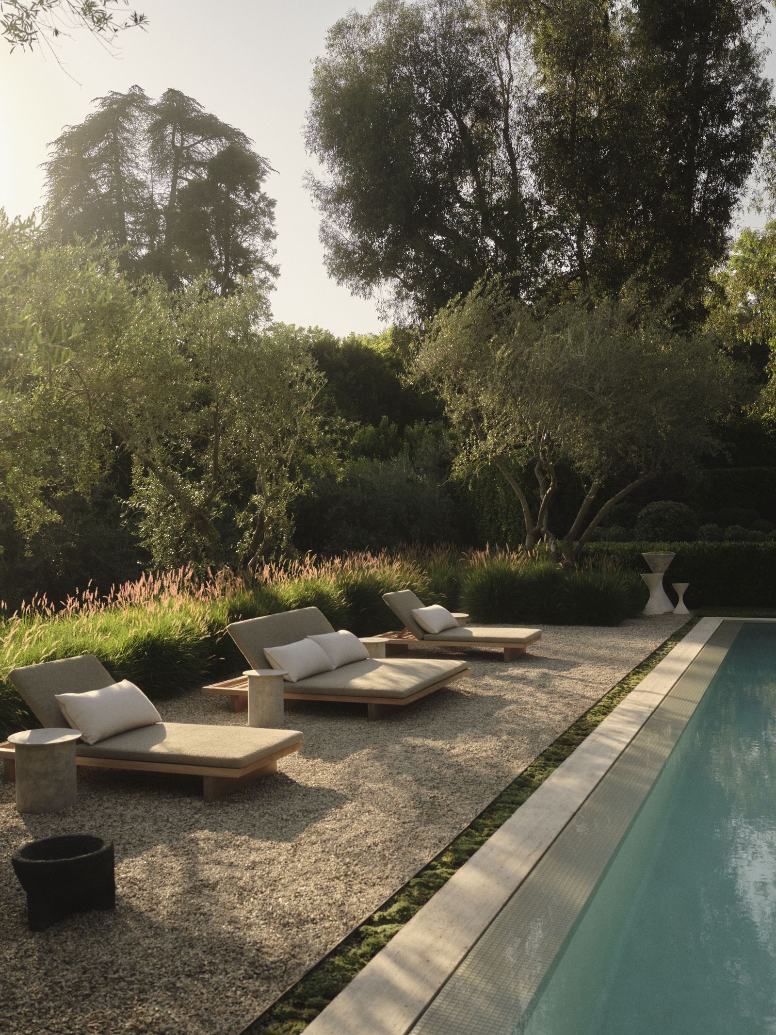 Image can contain back yard in the open yard chair furniture pool water grass plant swimming pool and couch