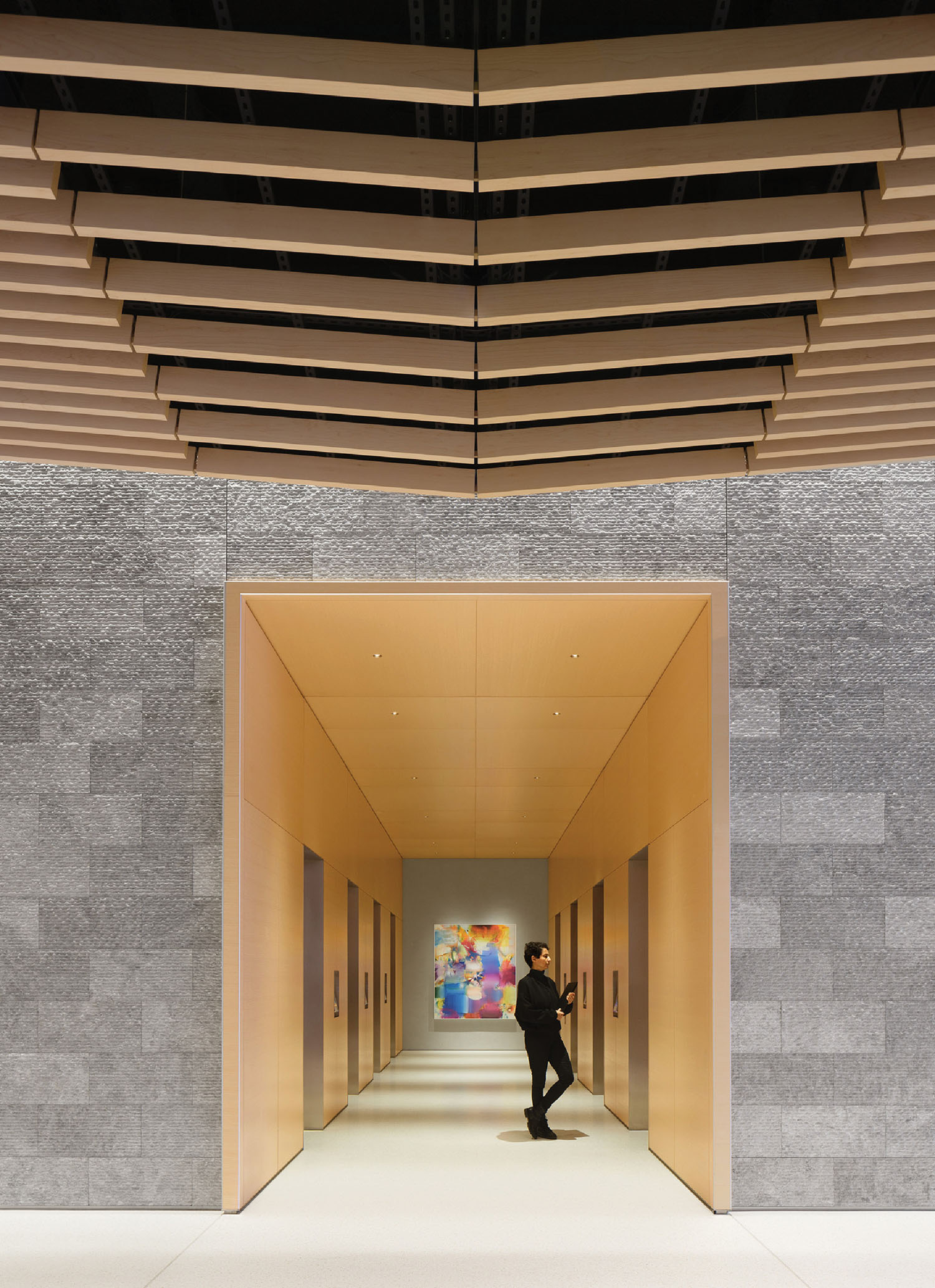 A man goes through a long hallway