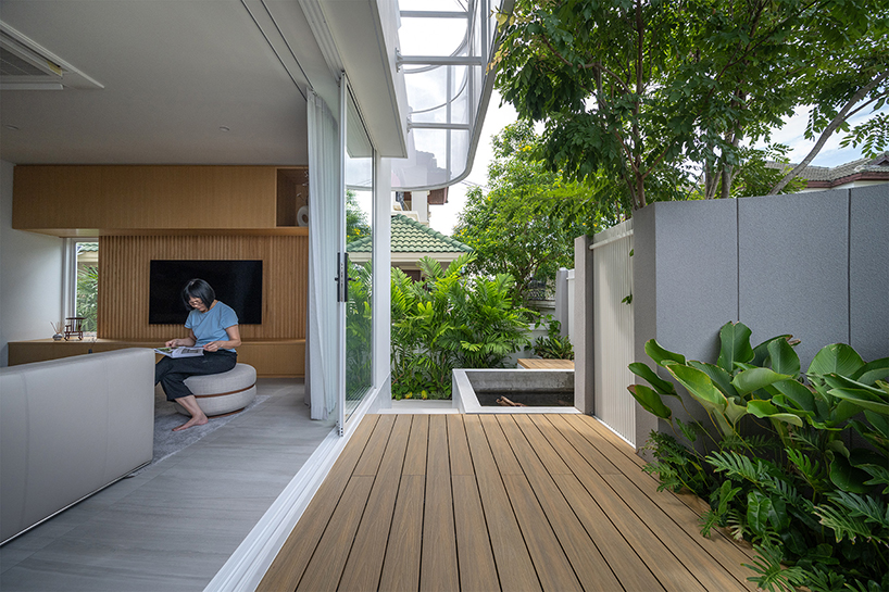 curved textile facades wrap the reborn house in Bangkok Village, which soft