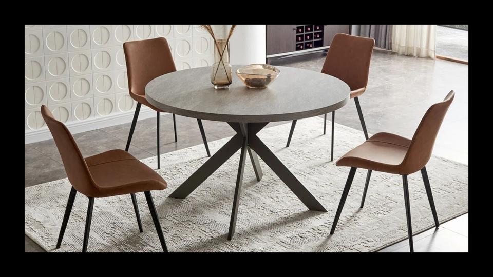 A picture of the latitude ran round dining table on a black background.