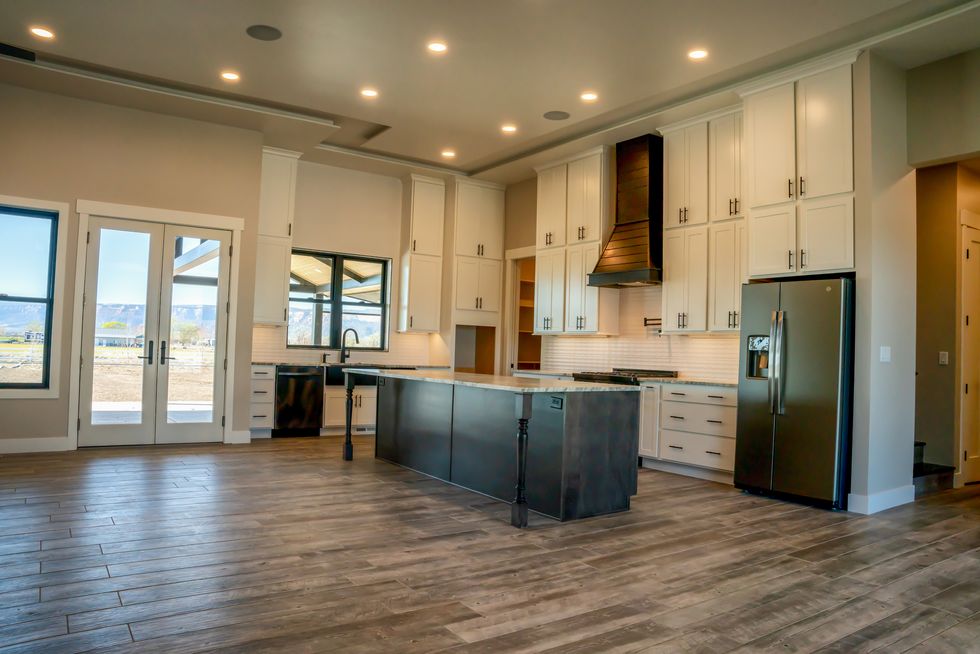 The inside of the kitchen of a newly built single -family house with an open concept