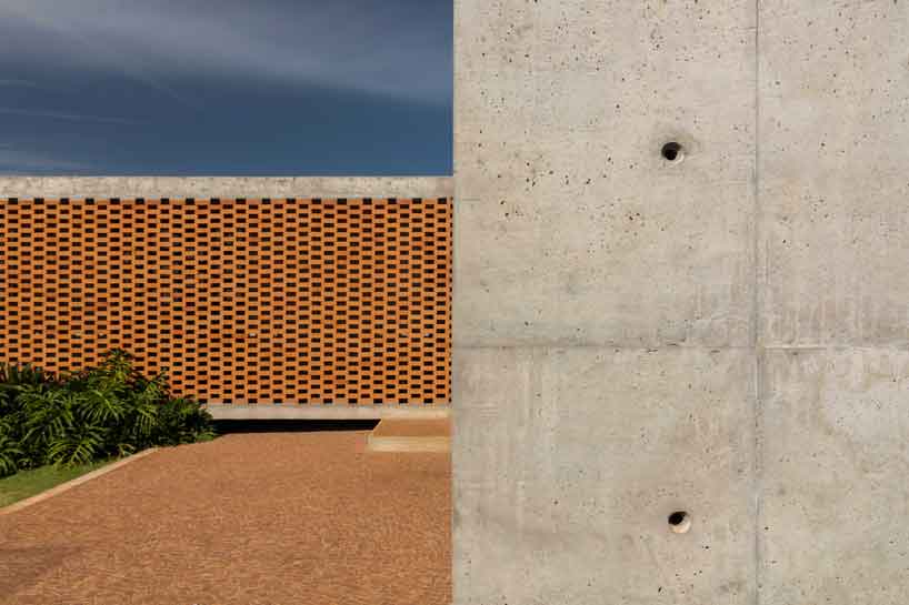 Perforated brick facade punctures Fernanda Padulas concrete house in Brazil