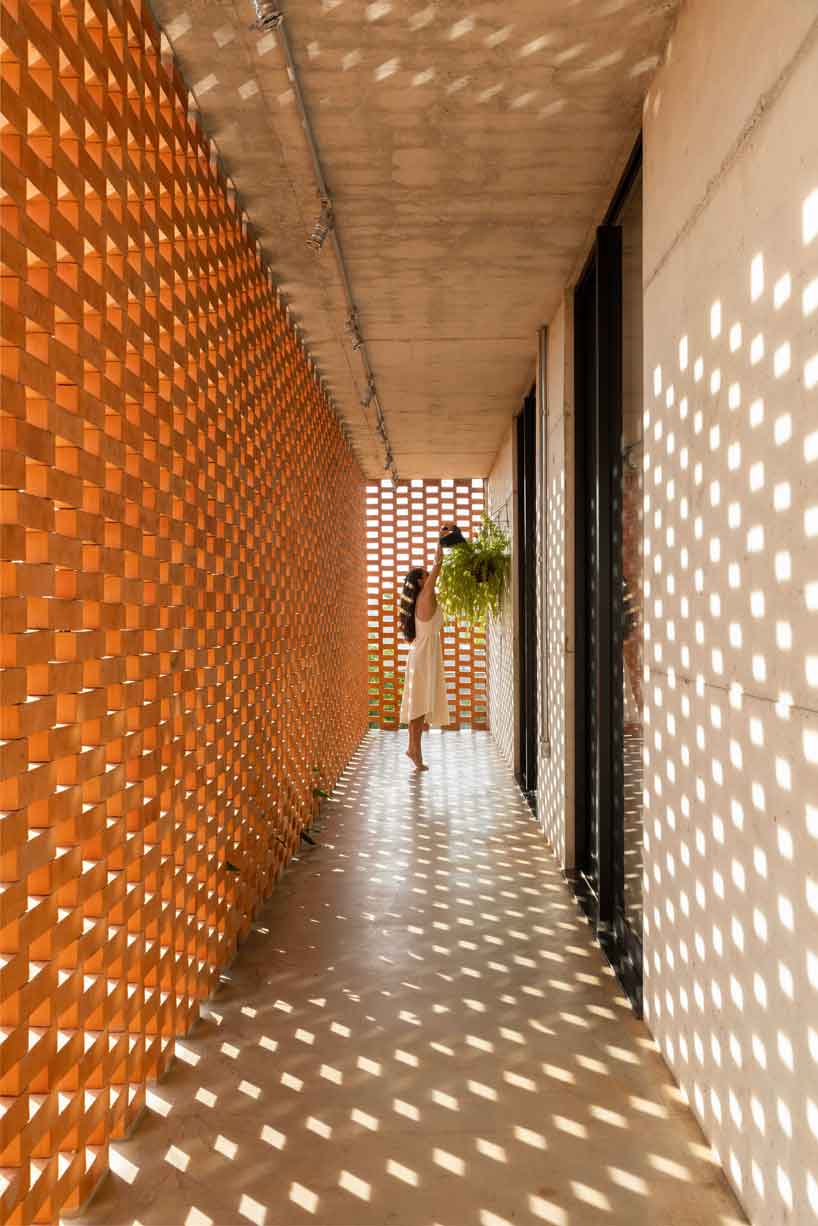 Perforated brick facade punctures Fernanda Padulas concrete house in Brazil