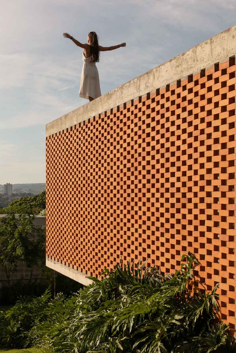 Perforated brick facade punctures Fernanda Padulas concrete house in Brazil