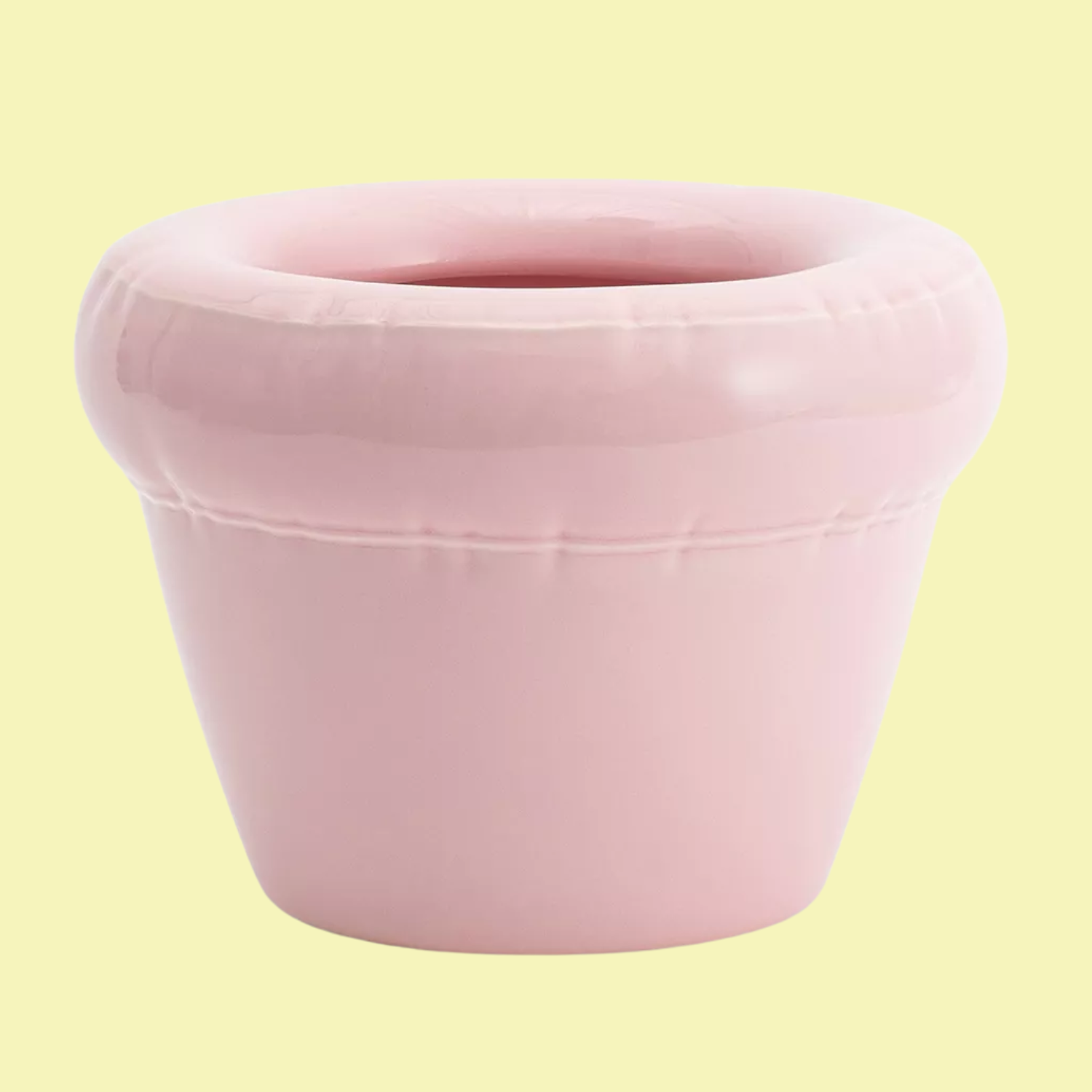 A bloody ceramic planter in a light bubblegum pink color