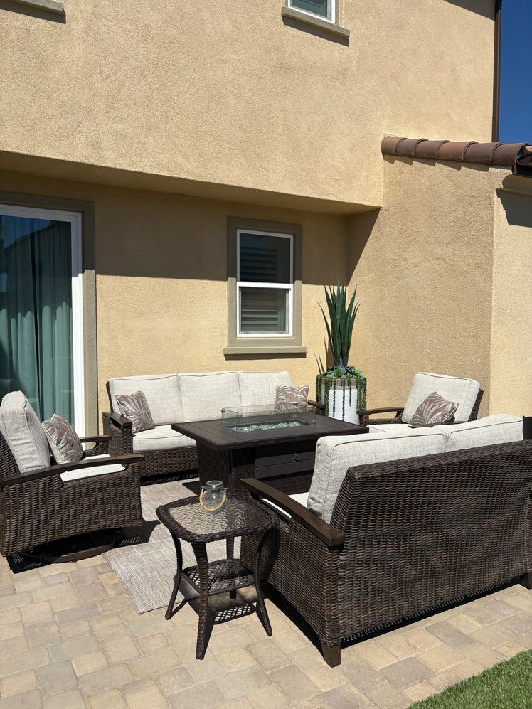 The right outdoor terrace with two sofas, chairs and a coffee and a side table.