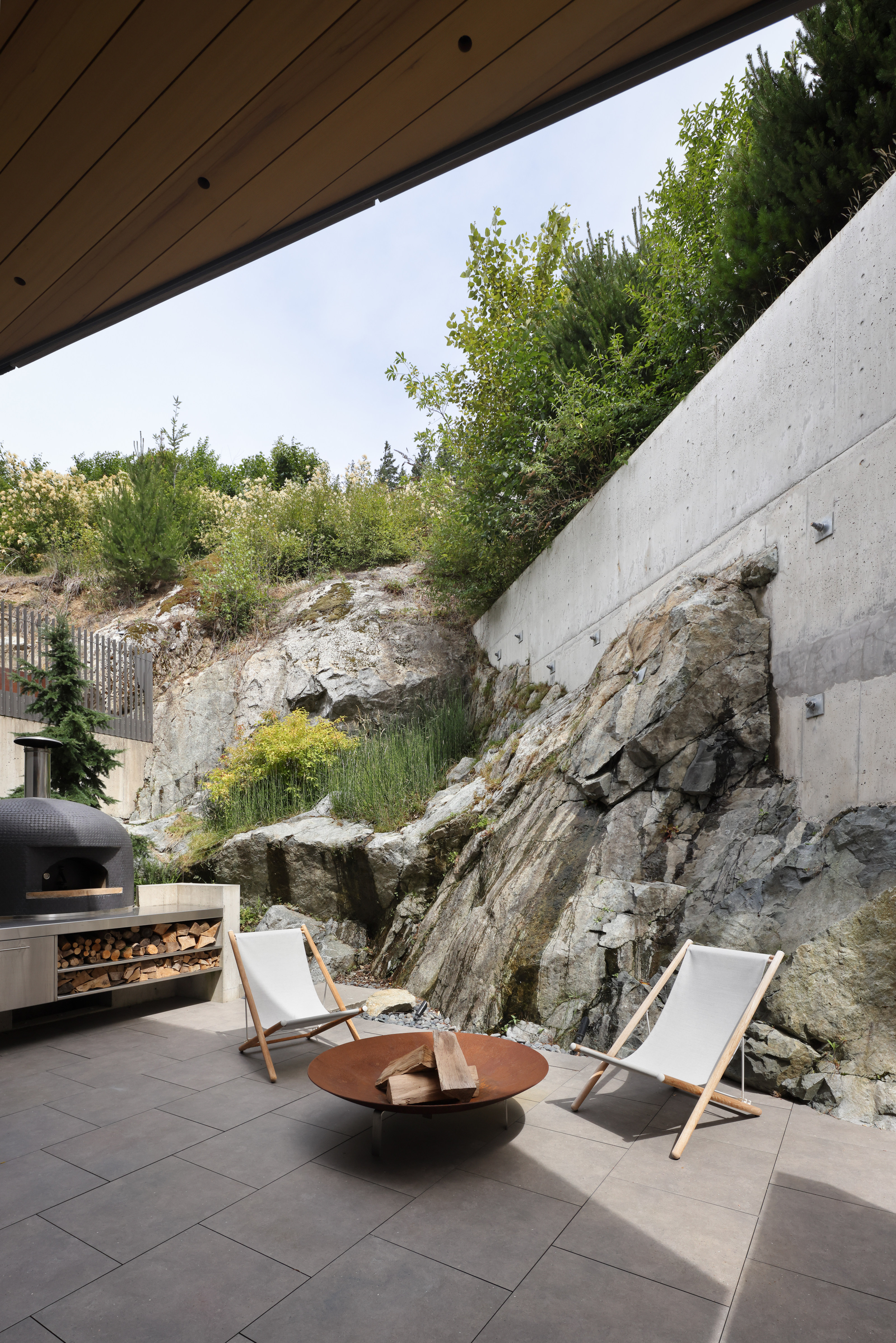 The rear terrace shows how the house is anchored in the rock
