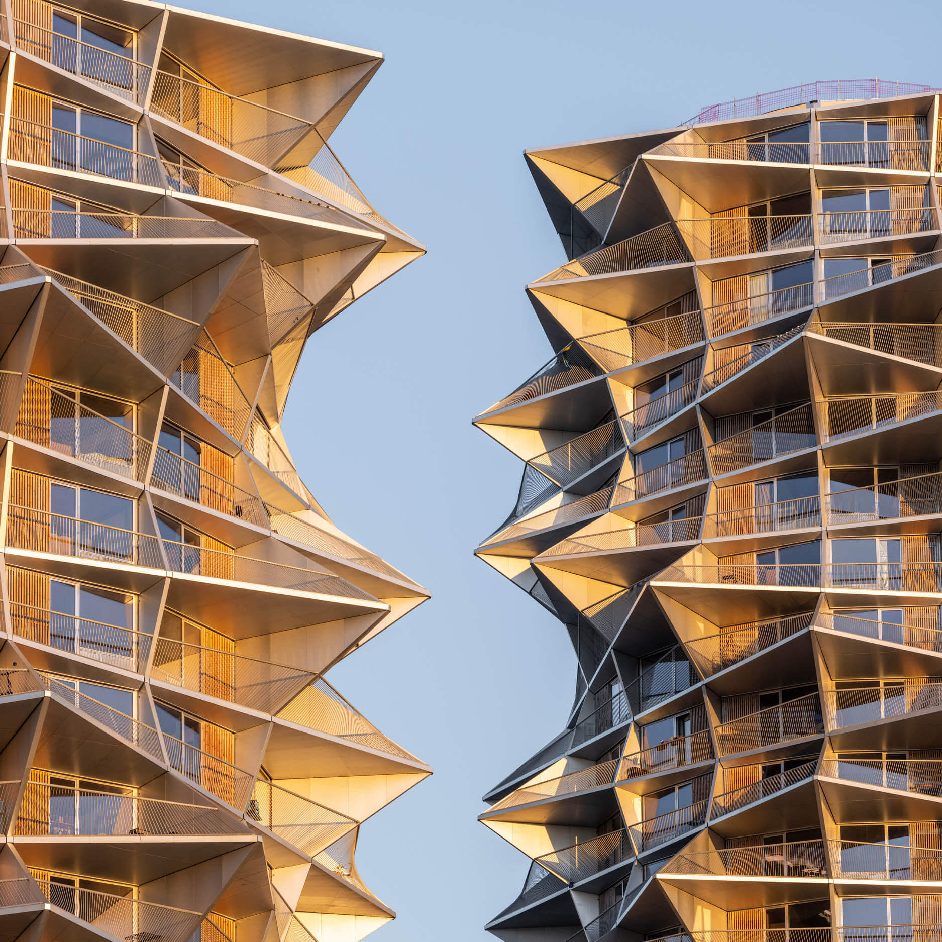 Twin top balcony facades, identical, jagged towers