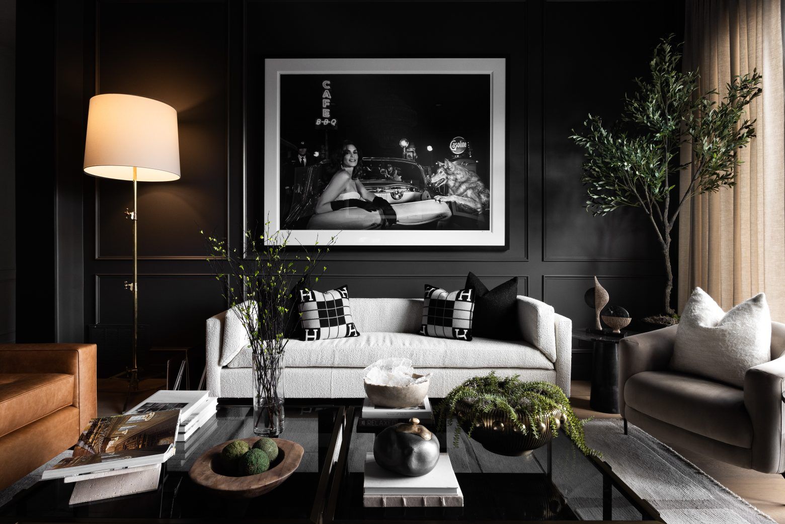 A living room with black walls and white furniture.
