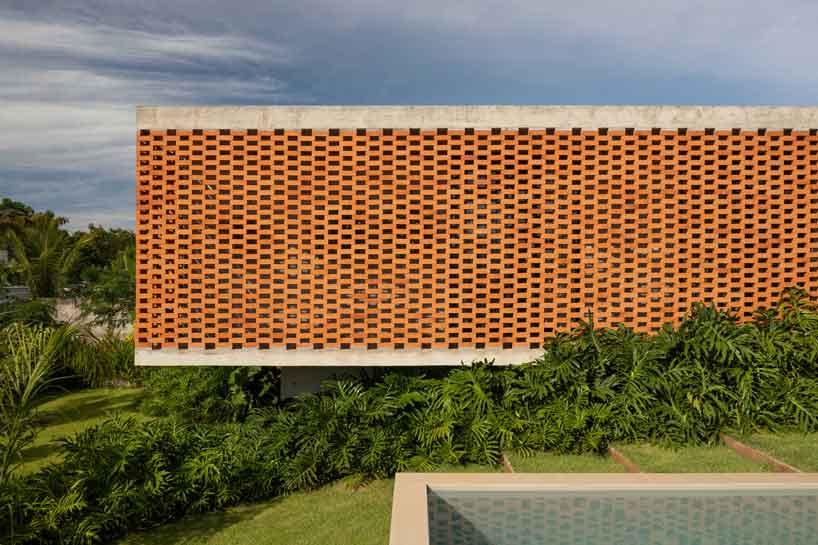 Perforated brick facade punctures Fernanda Padulas concrete house in Brazil