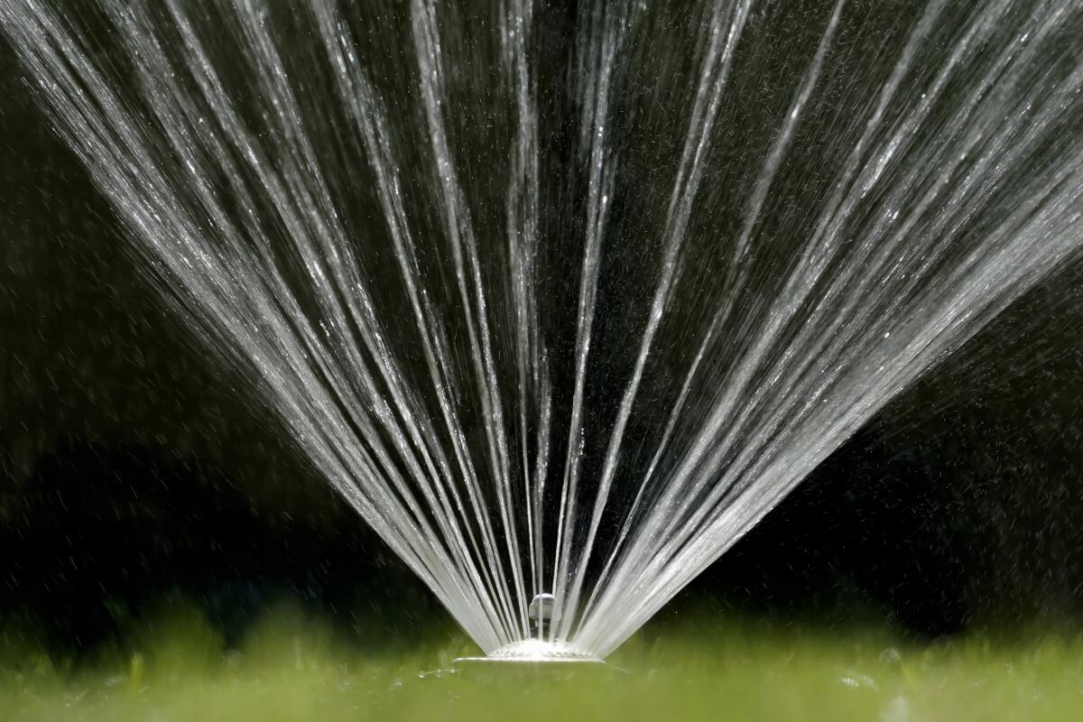 A sprinkler sends H2O jets into the air.