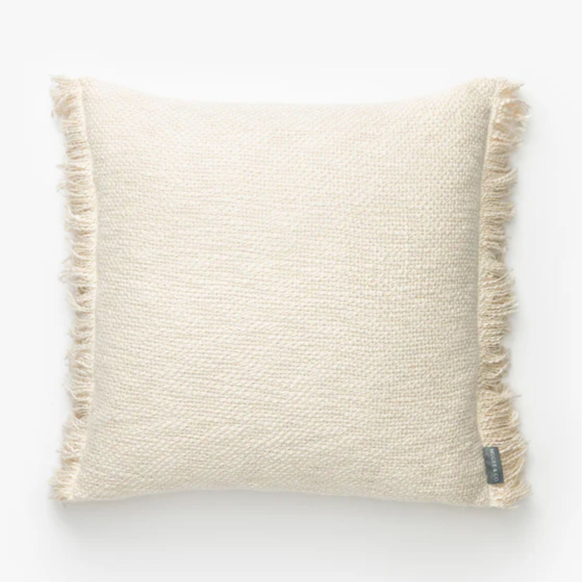 Square cream cushion with a tassel edge