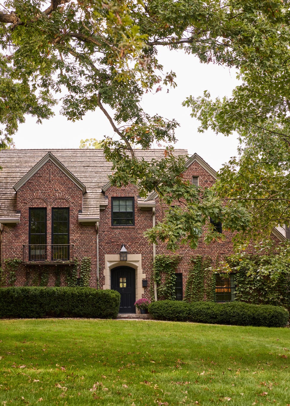 Housing brick house with green and open lawn.