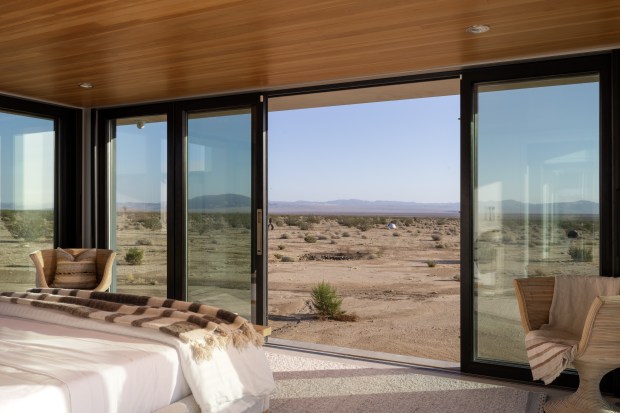 Glass walls open up for seamless indoor-outdoor living. (Photo by Andrew...