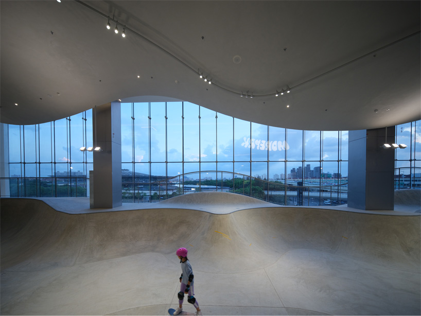 The curved urban skate park set within a floating glass volume offers views of the Shanghai skyline