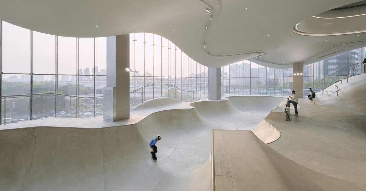 The curved urban skate park in a floating glass volume overlooks the Shanghai skyline