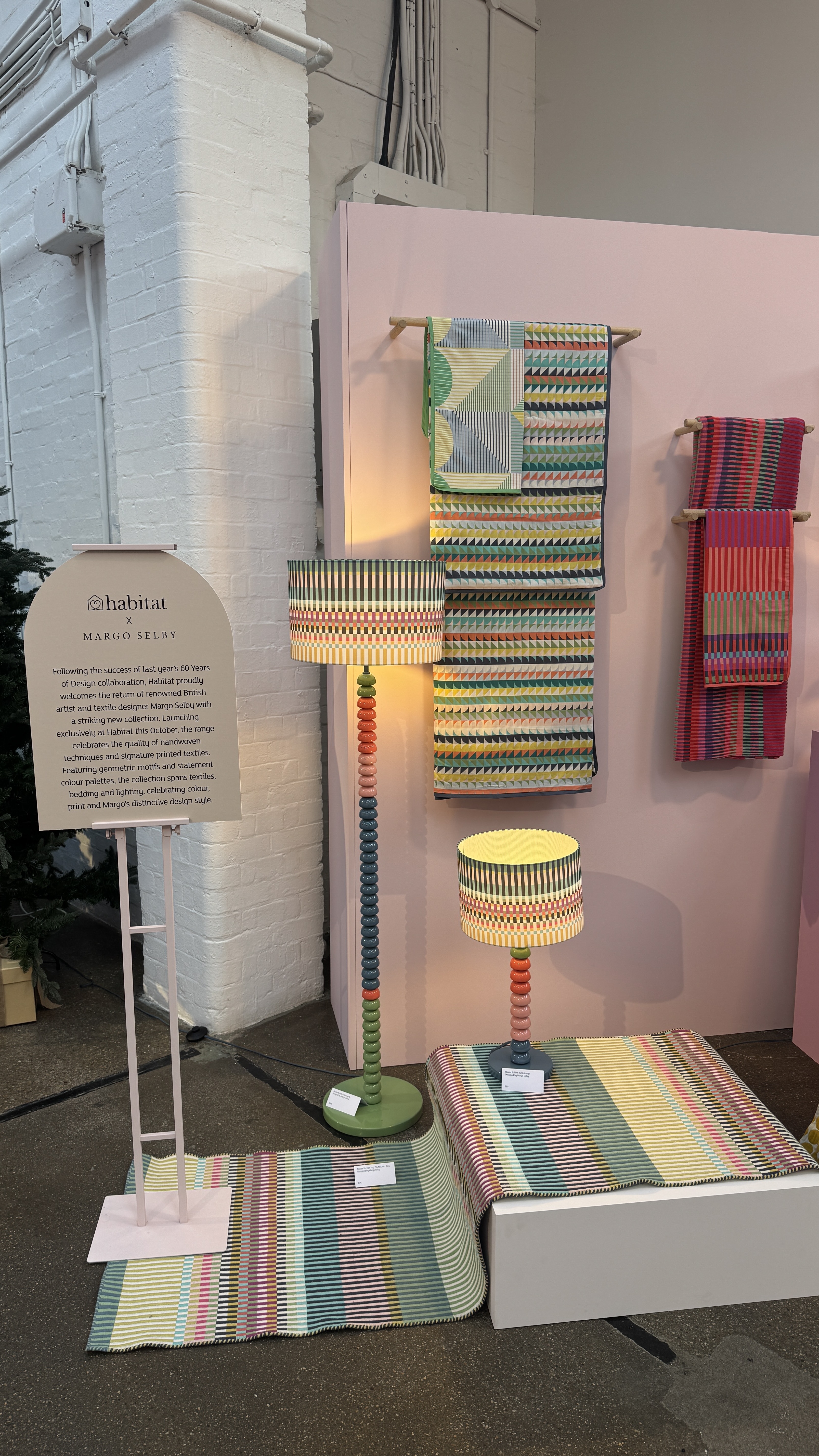 Colorful coil lamps on a colorful carpet with colorful towels in the background