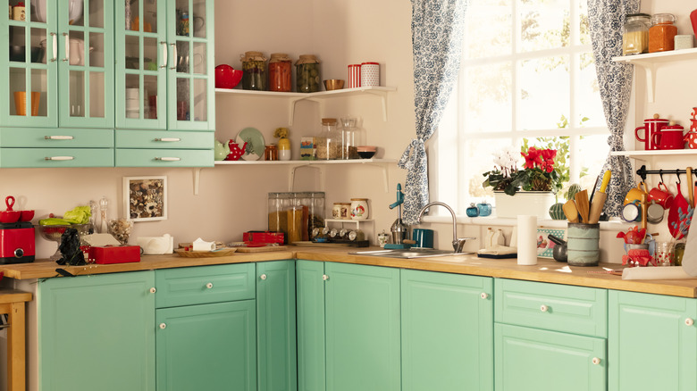 Kitchen with light mint green furniture.