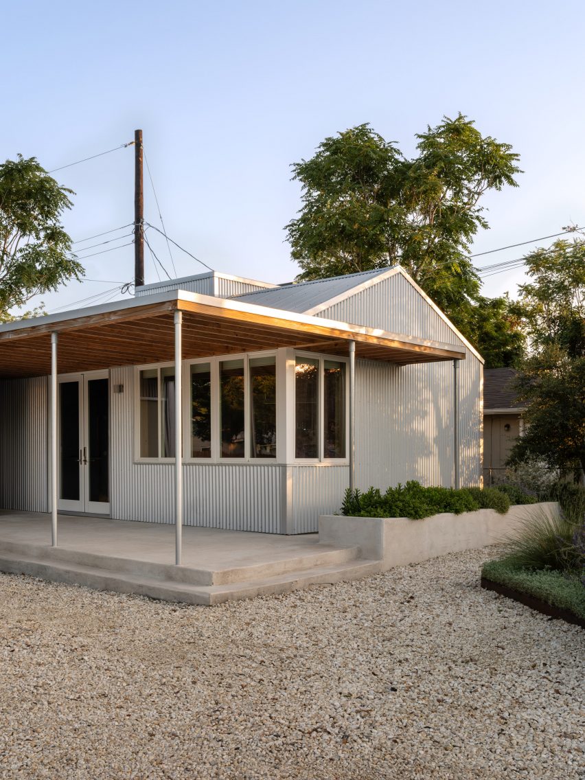 Outside of a gable building with a large canopy and a metal cladding