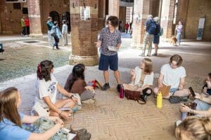 Students in a museum in Italy listen to a lecture