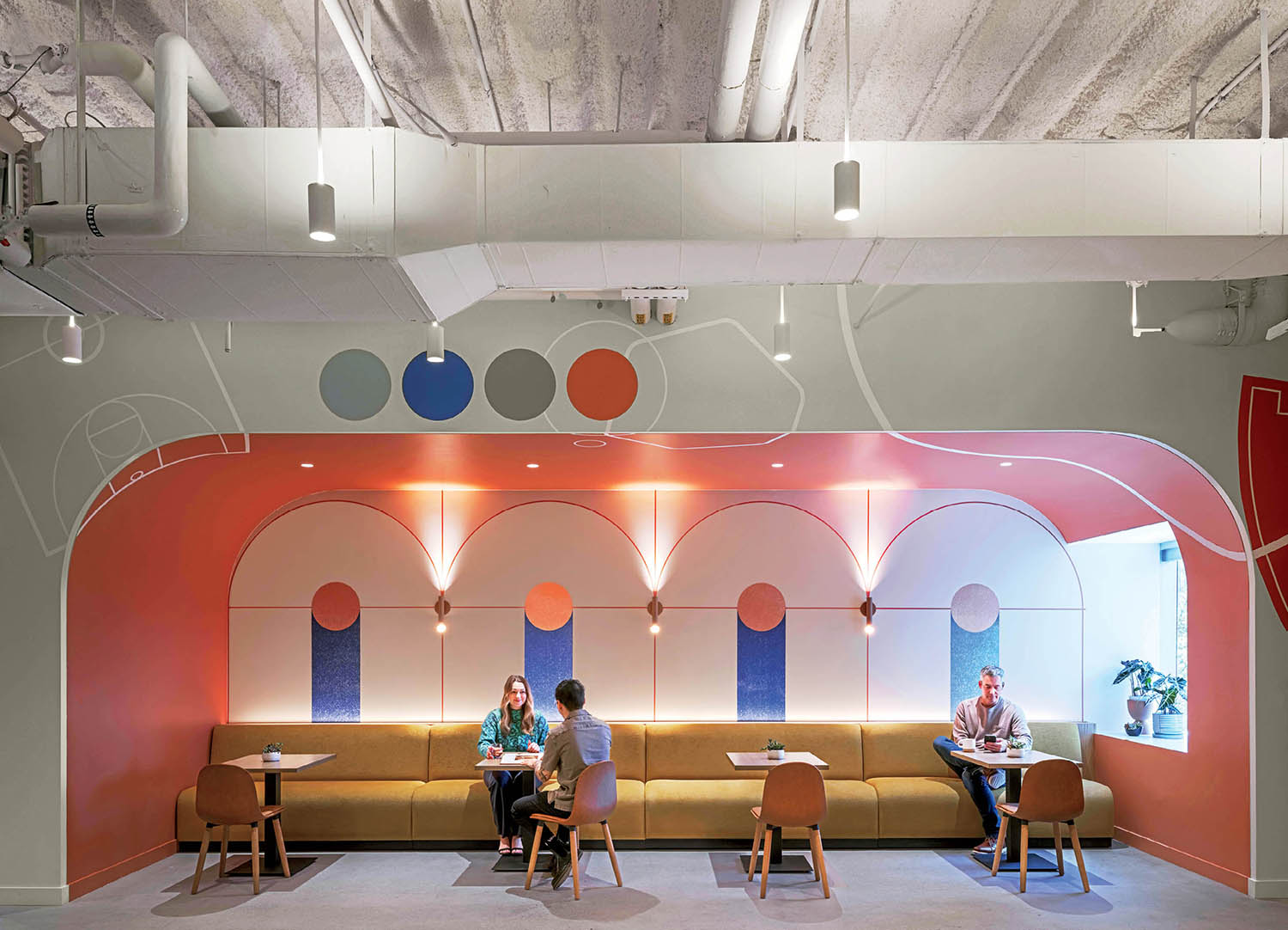 A few people are sitting at a table in a room.