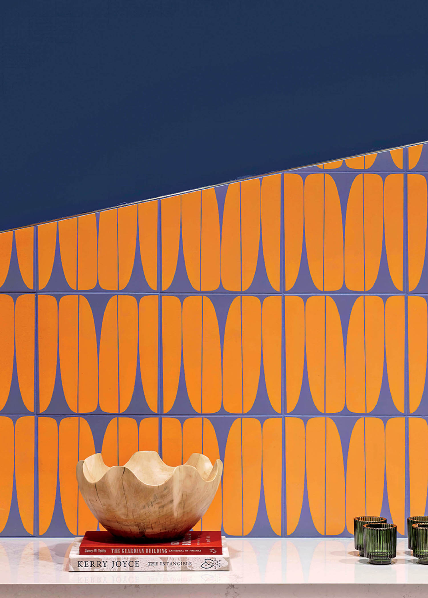 A white table with a vase and wallpaper.