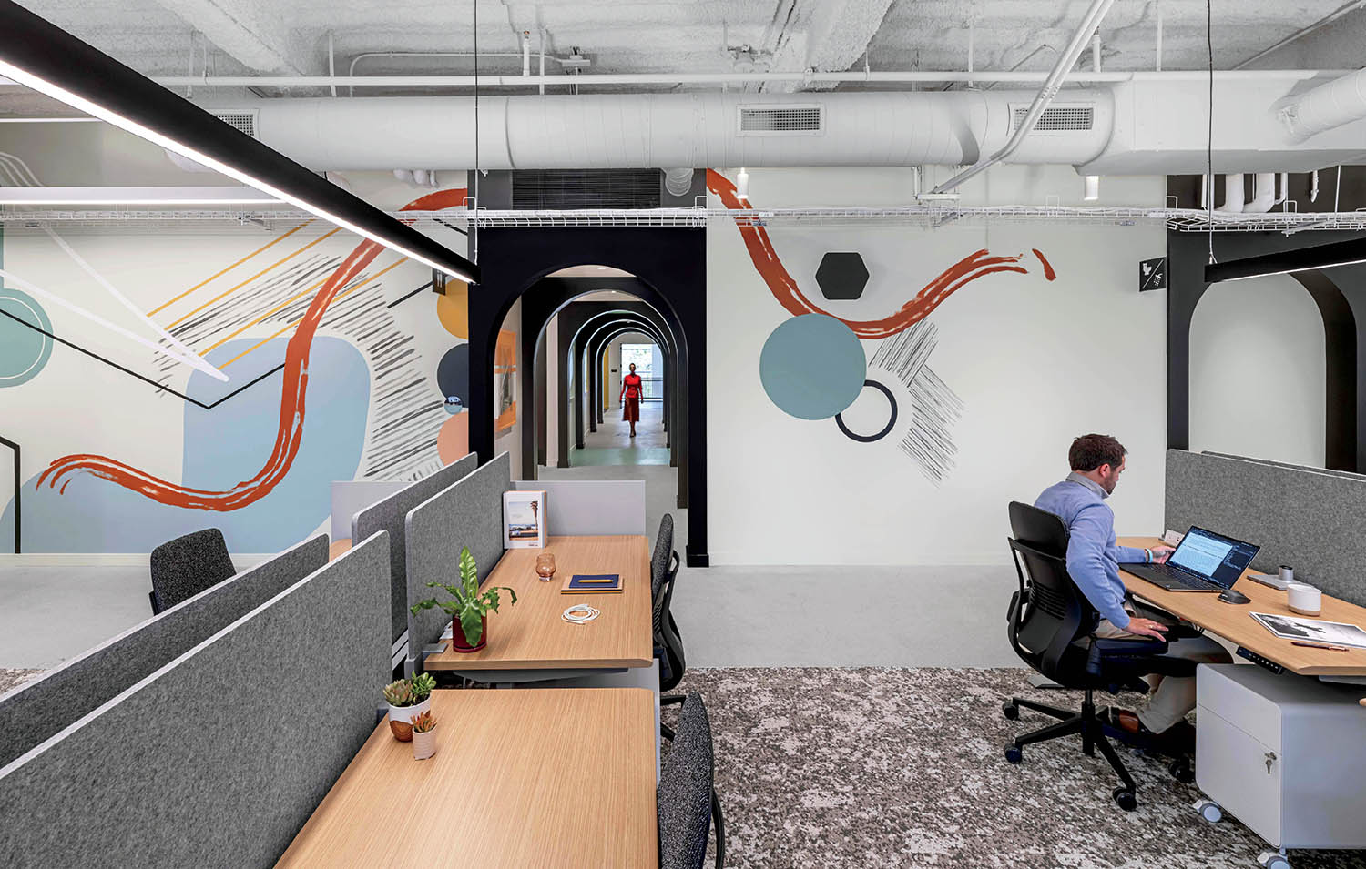 A man sits at a desk in an office.