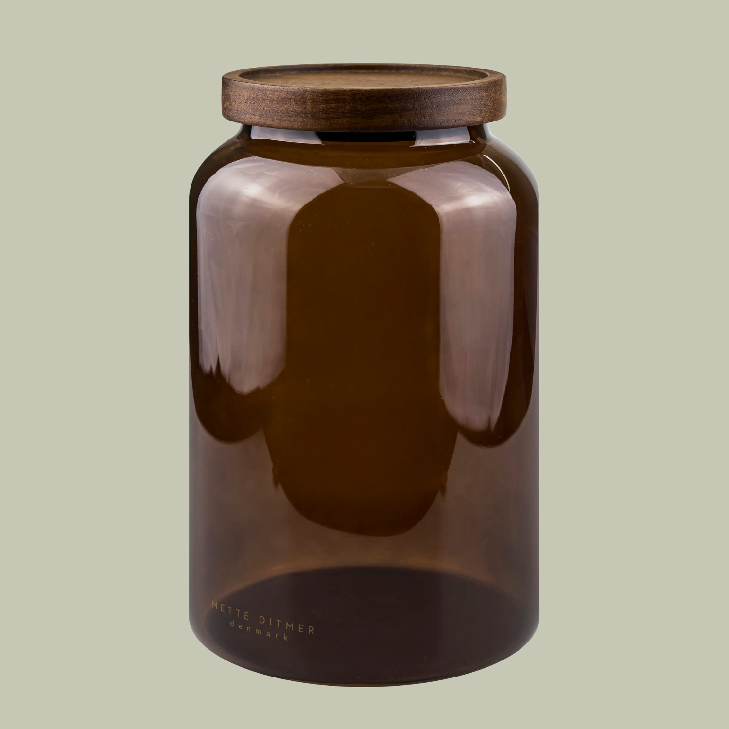 A brown glass jar with a wooden lid