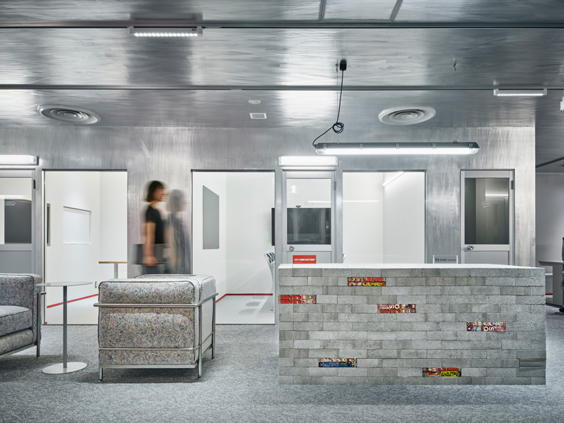 Reflective aluminum creates dynamic movement effects in the manga studio in Tokyo