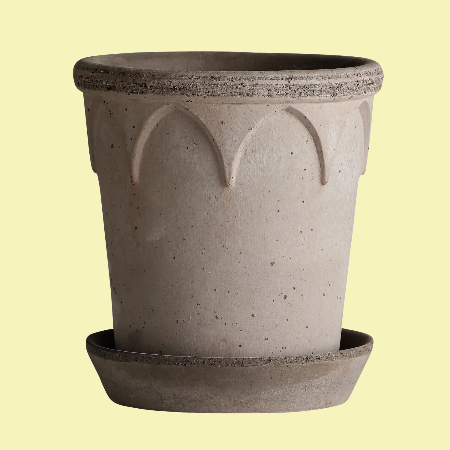 A flower pot and saucer made from raw clay