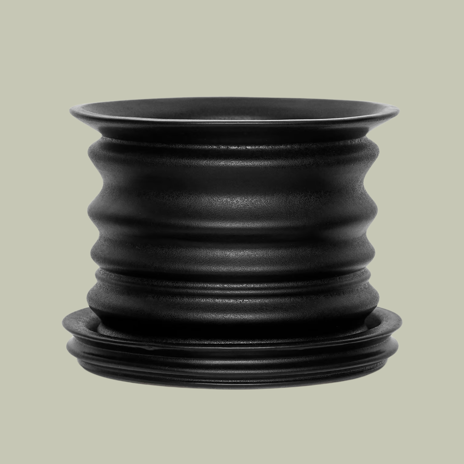 A fluted black planter and saucer