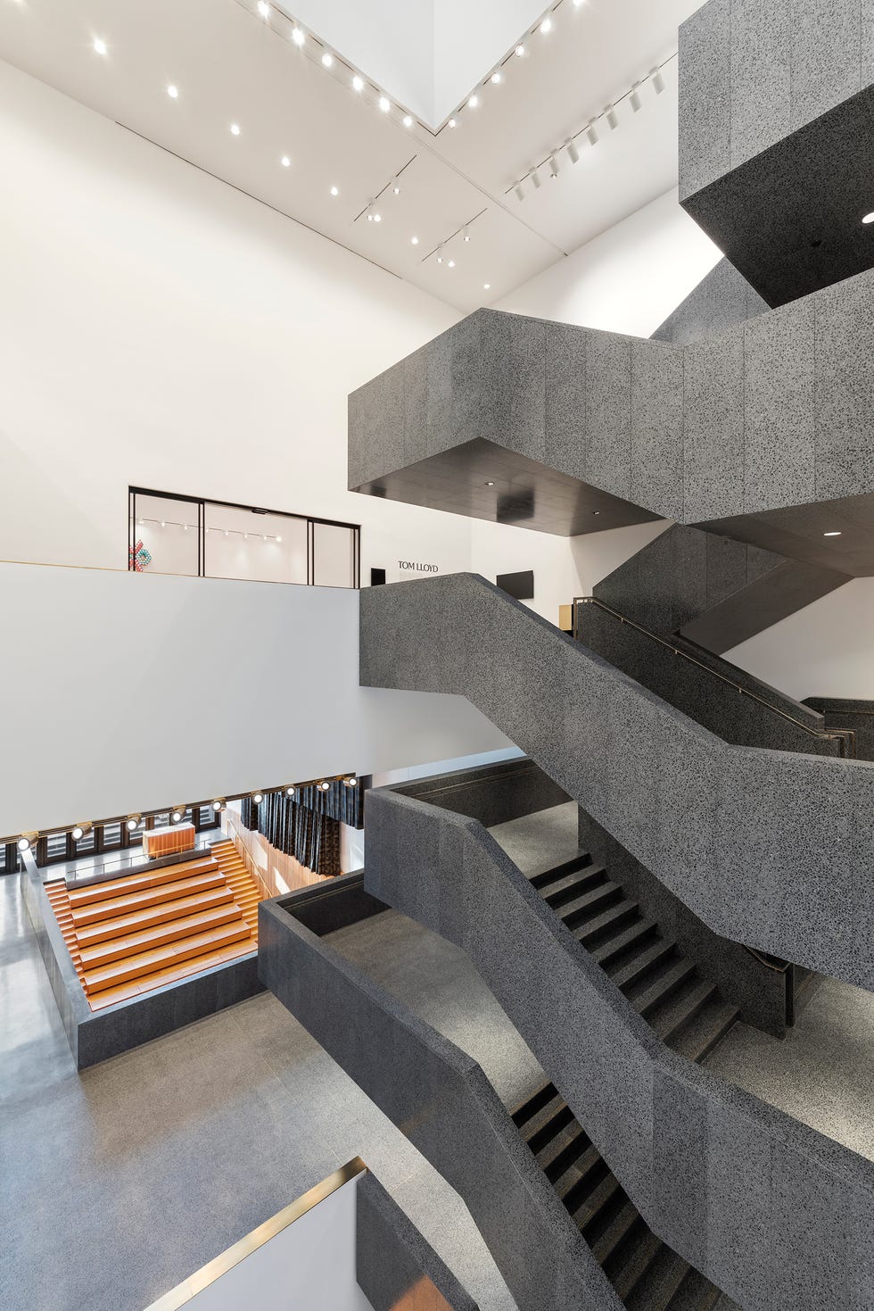 Interior view of a modern architectural space with stairs and seating.