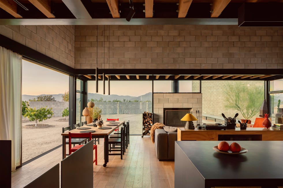Open kitchen and dining area with modern design elements and views of the outdoors.