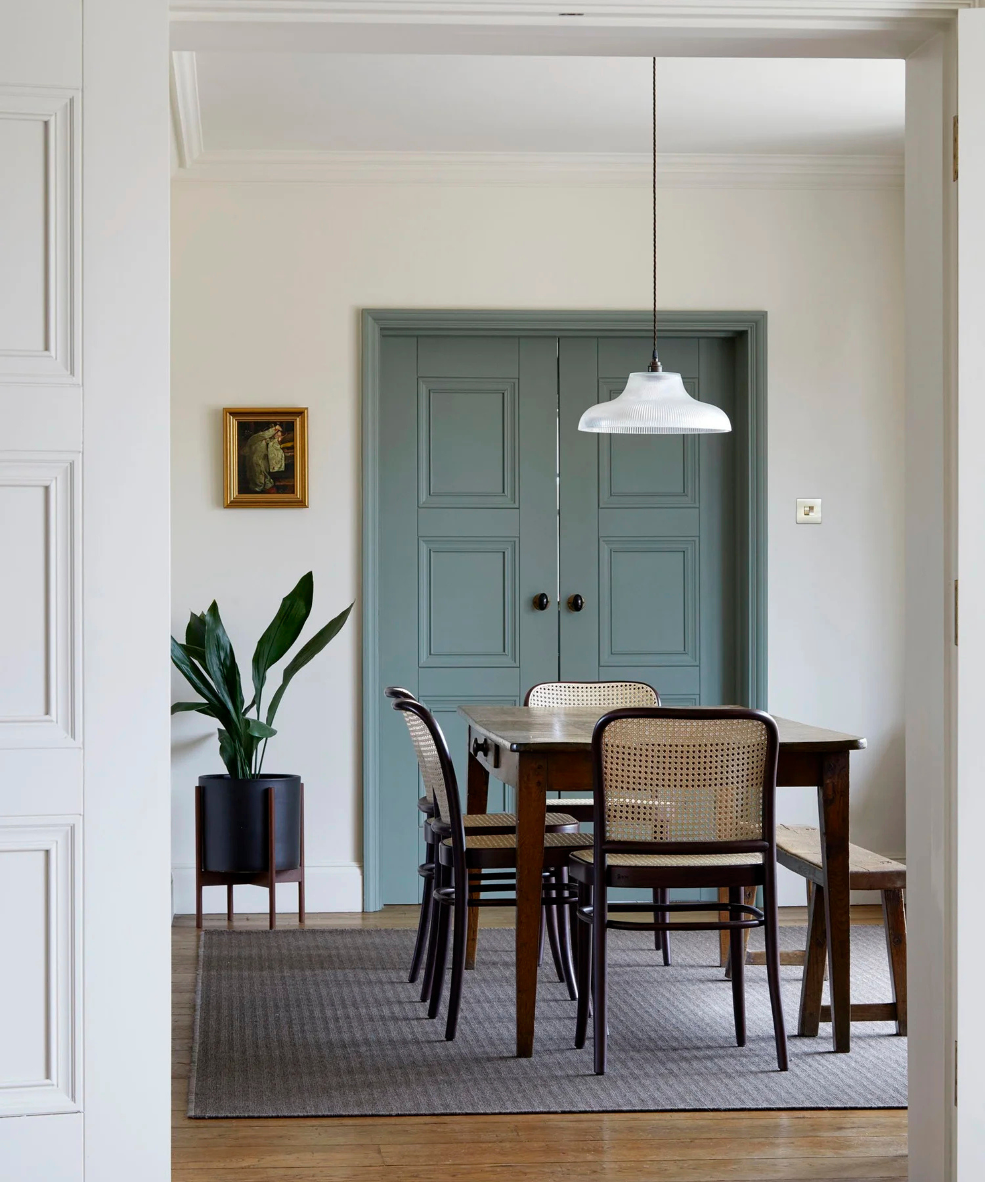 a dining room with blue painted doors