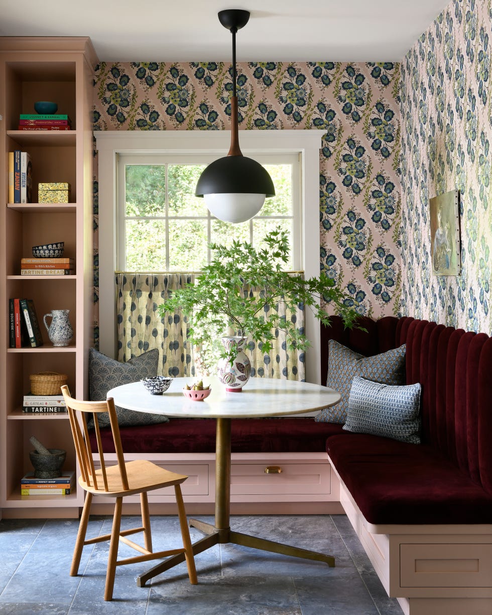 Breakfast nook with bench, blush built-in furniture and patterned wallpaper