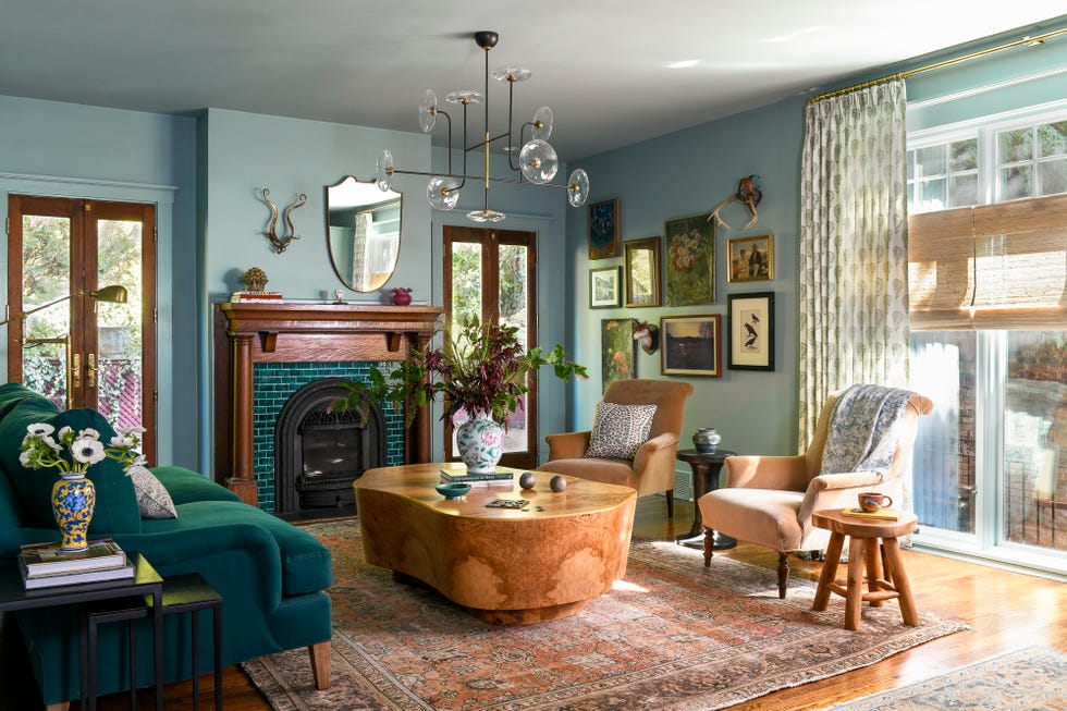 Living room with blue walls, floating seating area and collected gallery wall