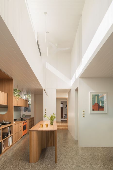A double-height room above the kitchen is lit by clerestory windows. Artwork: Paul Catherall.