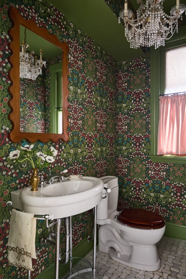 Victorian style bathroom with floral wallpaper, sink and toilet
