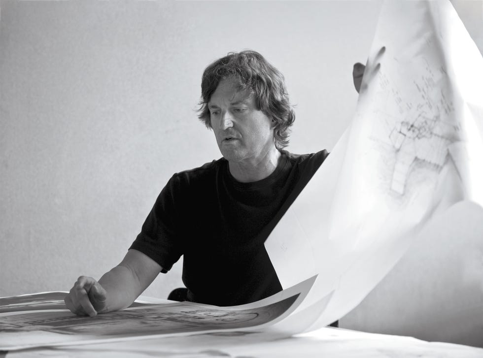 Person holds a large blueprint.