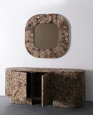 Decorative wooden sideboard with open doors and matching wall mirror with an intricate mosaic floral pattern.